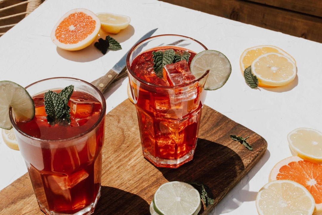 Assortment of autumn-themed cocktails including spiced apple cider and creamy drinks by a fire pit