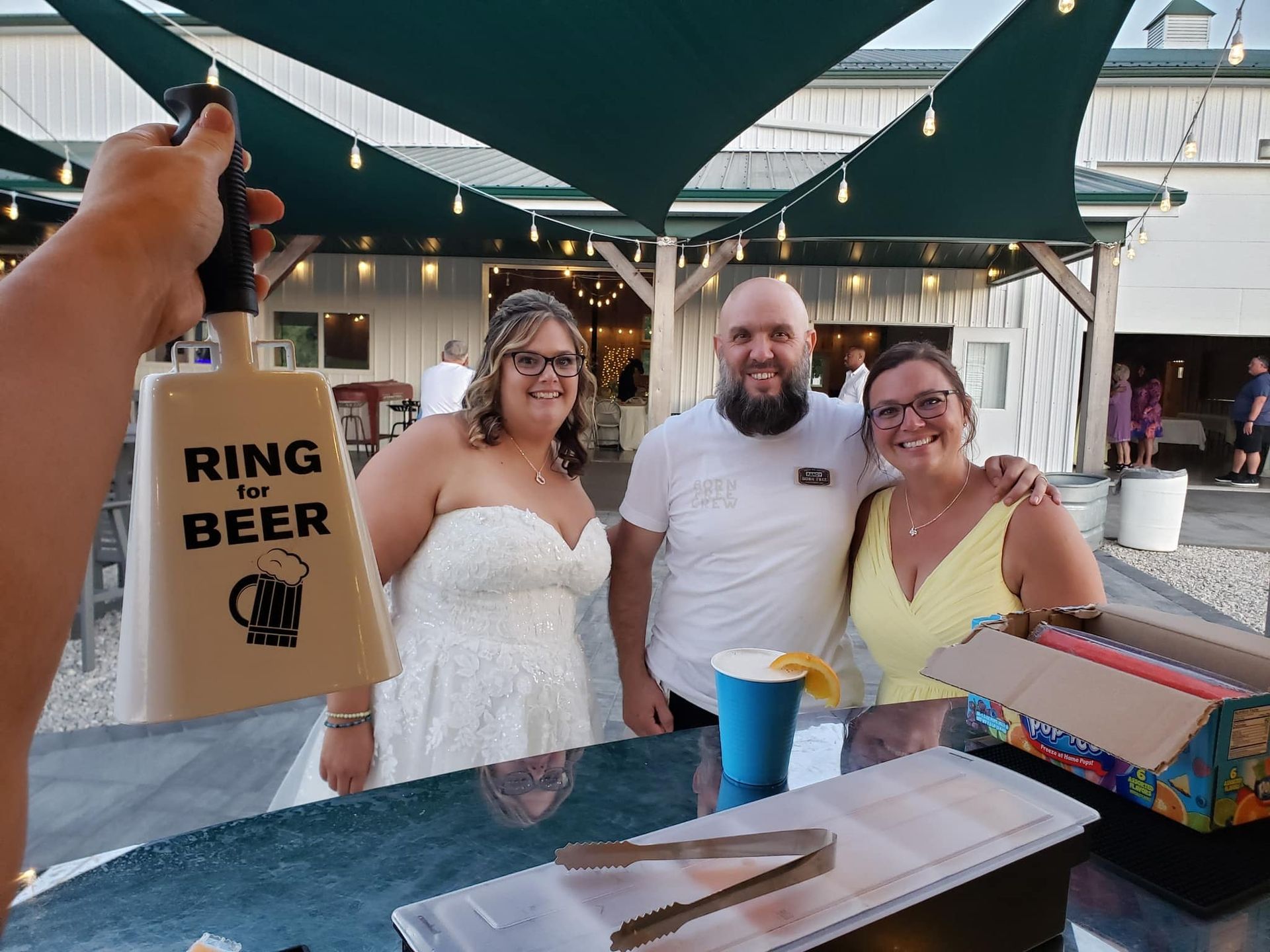 Founder Randy posing with a bride and groom at their wedding