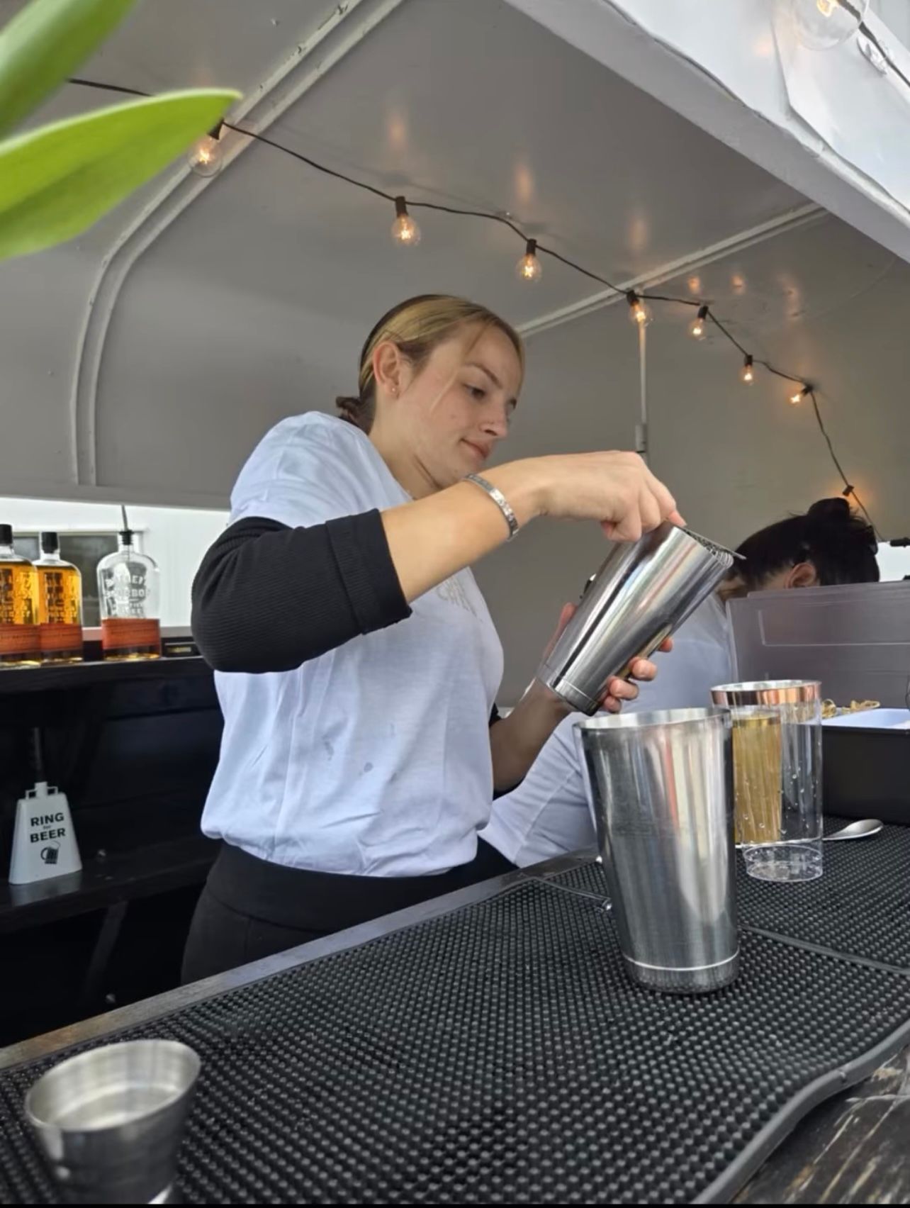 Bartender inside the mobile bar trailer, view from the side