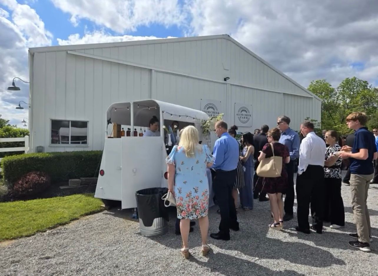 Guests interacting with staff at the mobile bar trailer